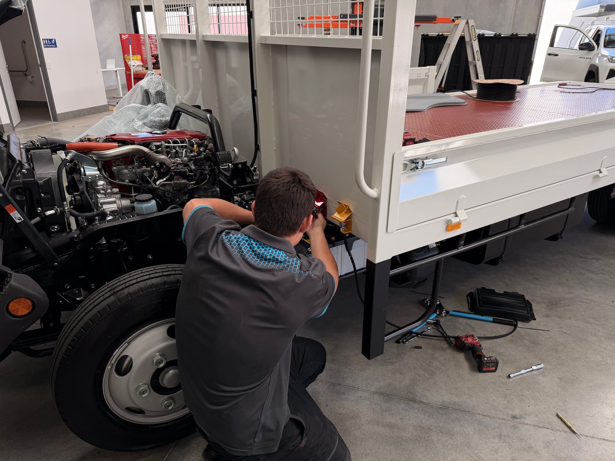 RAEG technician fitting isolators to a Hino 300