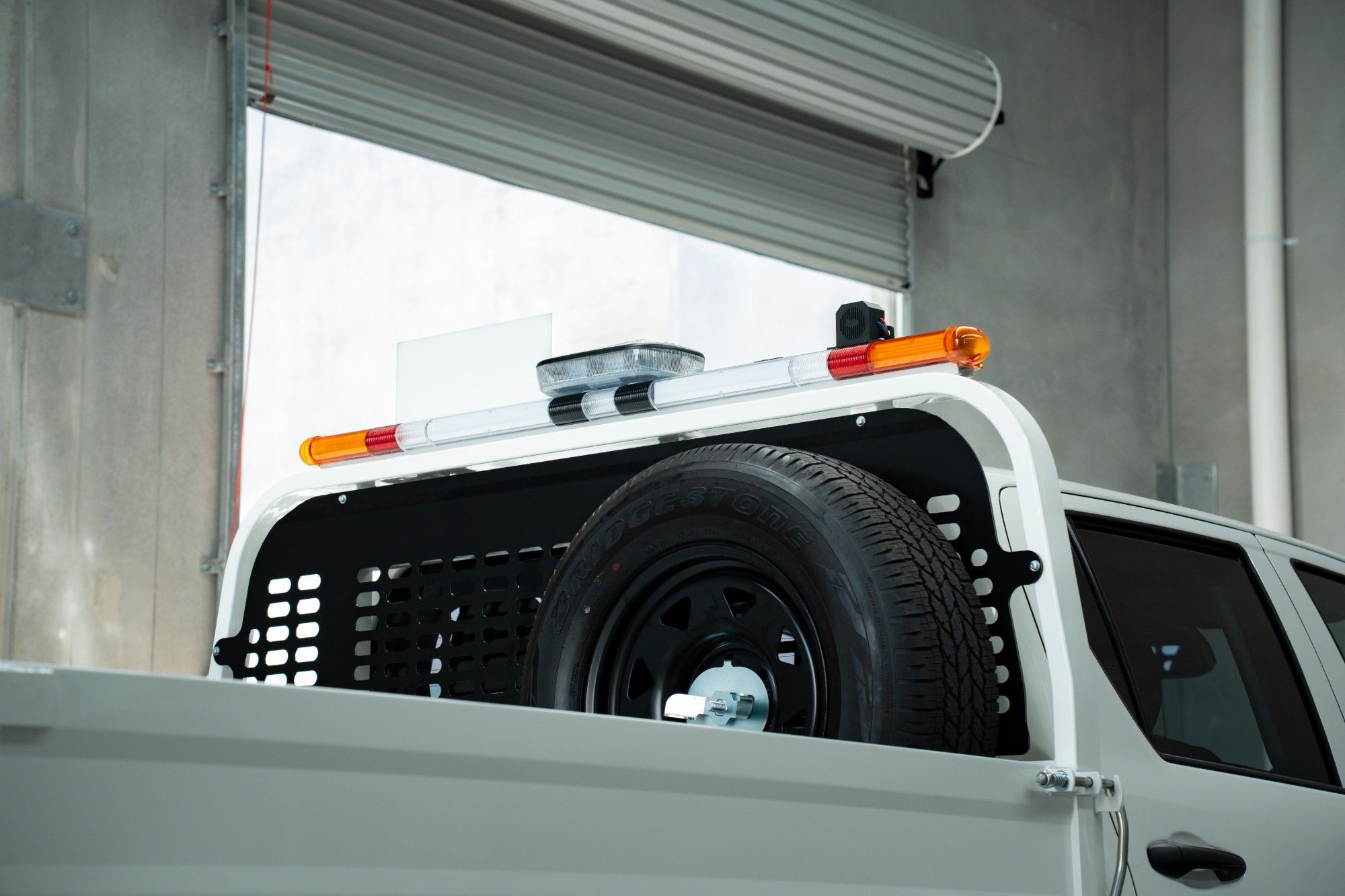 Hilux tray fitted with a mine bar and spare wheel carrier